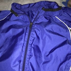 purple/bluish white and black wind breaker, full zip up.